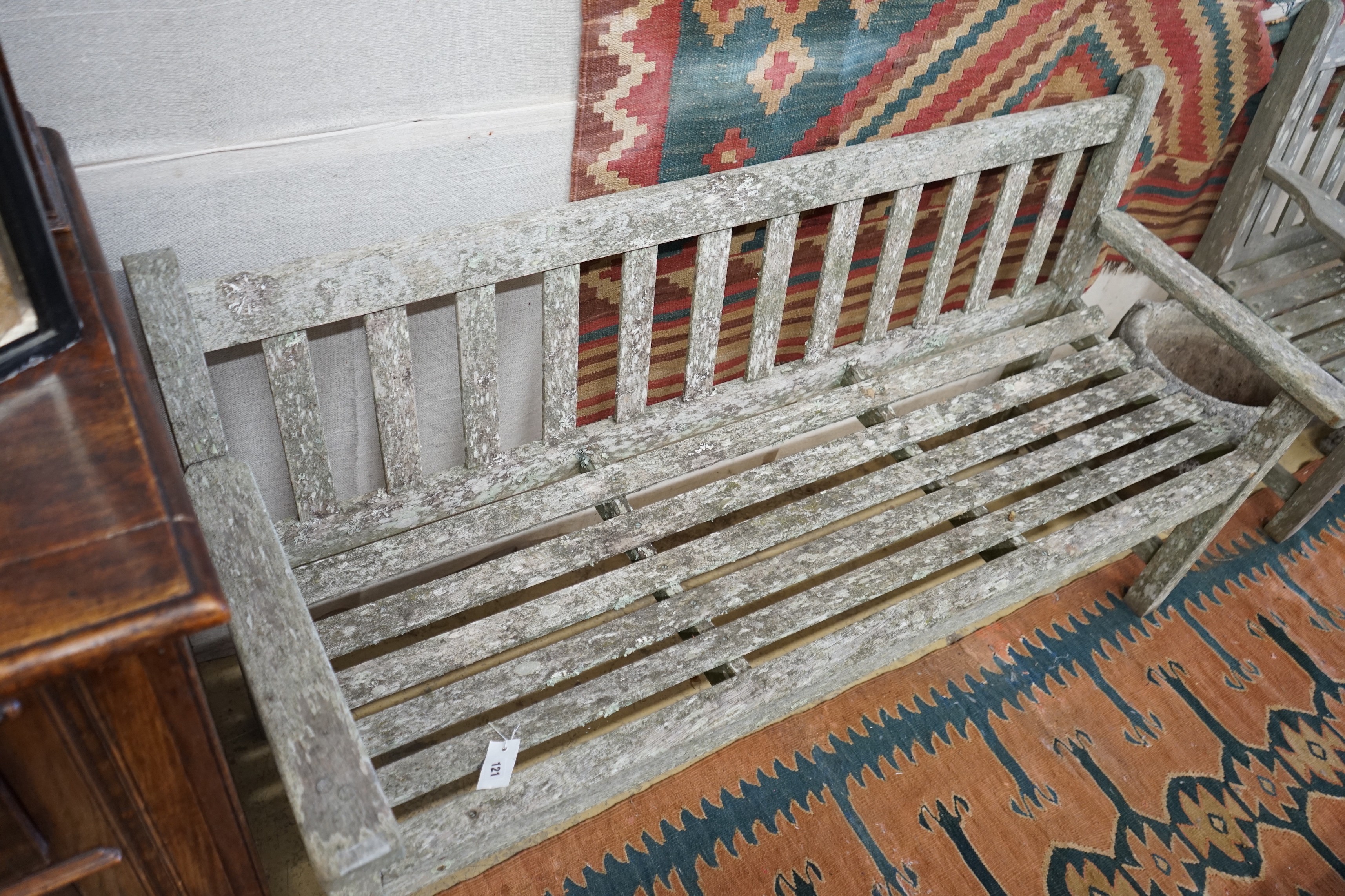 A near pair of weathered slatted teak garden benches, larger length 155cm, depth 56cm, height 90cm